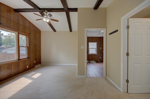 1318 N Prairie Ave, Joliet, IL 60435 - unfurnished room featuring wooden walls, light carpet, and a ceiling fan