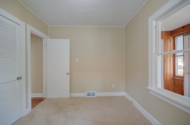 1318 N Prairie Ave, Joliet, IL 60435 - carpeted empty room with crown molding and a textured ceiling