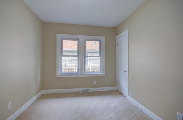 1318 N Prairie Ave, Joliet, IL 60435 - spare room with light colored carpet and baseboards