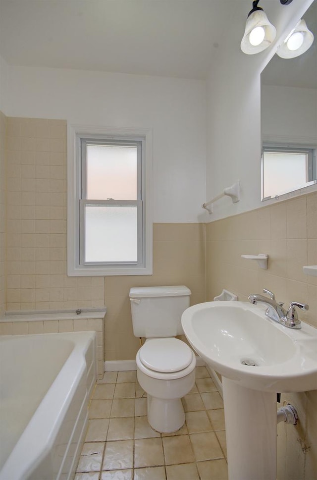 1318 N Prairie Ave, Joliet, IL 60435 - full bathroom with a tub, plenty of natural light, and tile patterned floors