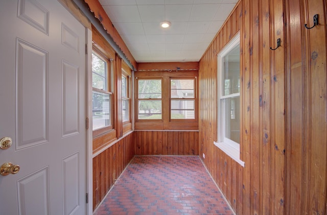 1318 N Prairie Ave, Joliet, IL 60435 - unfurnished sunroom featuring brick flooring and wood walls