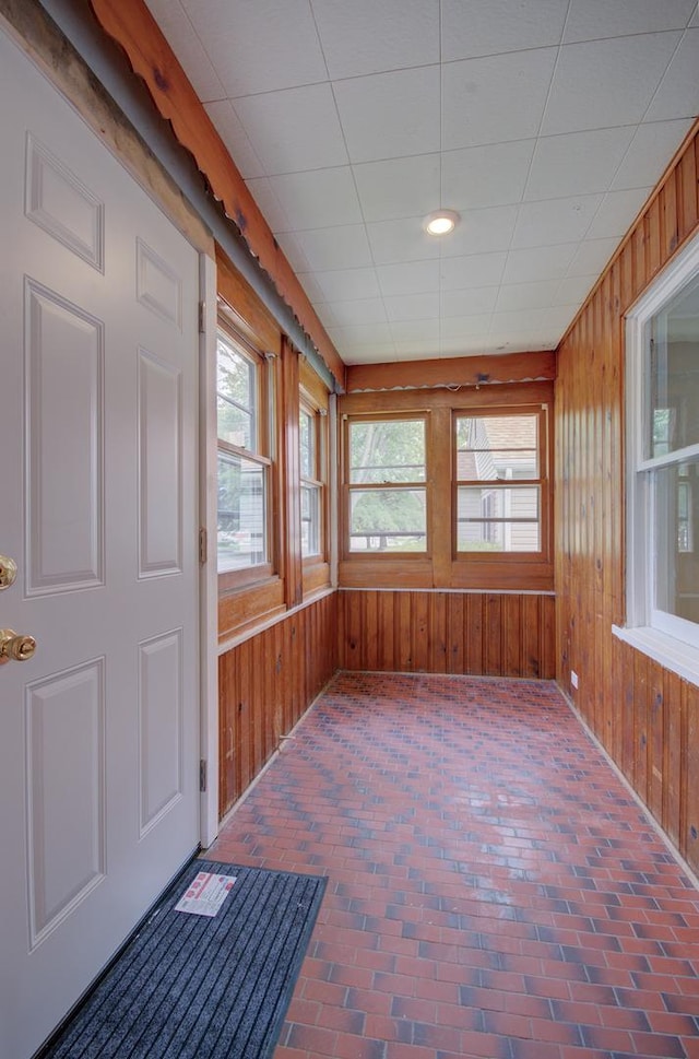 1318 N Prairie Ave, Joliet, IL 60435 - unfurnished sunroom with brick flooring and wooden walls