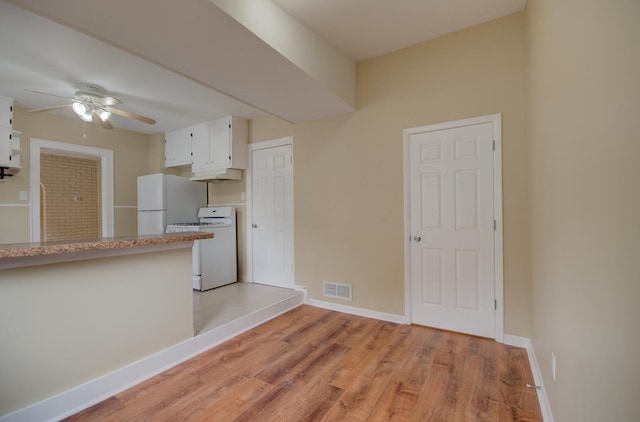 1318 N Prairie Ave, Joliet, IL 60435 - kitchen featuring white appliances, under cabinet range hood, ceiling fan, white cabinets, and light wood-type flooring