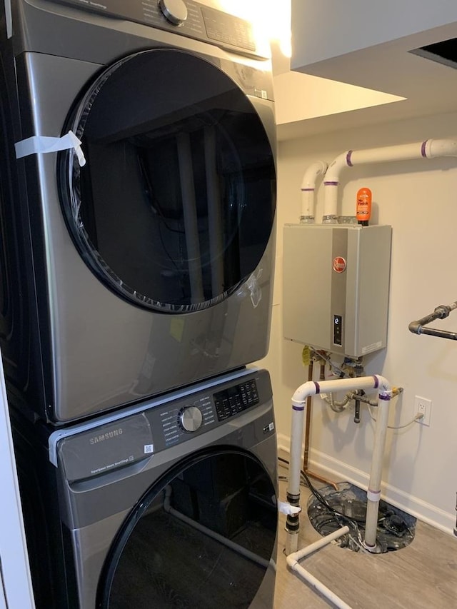 2155 N Mobile Ave, Chicago, IL 60639 - washroom with stacked washer and clothes dryer and tankless water heater