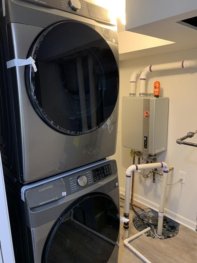 2155 N Mobile Ave, Chicago, IL 60639 - washroom with stacked washer and clothes dryer and tankless water heater