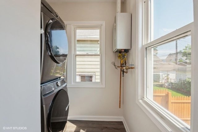 2155 N Mobile Ave, Chicago, IL 60639 - washroom with stacked washer / dryer, water heater, healthy amount of natural light, and wood finished floors