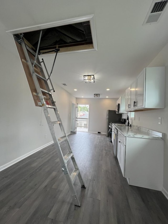 2155 N Mobile Ave, Chicago, IL 60639 - kitchen with white cabinets, dark wood-type flooring, light countertops, recessed lighting, and appliances with stainless steel finishes