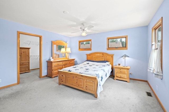 712 S Finley Rd, Lombard, IL 60148 - bedroom with light colored carpet, a ceiling fan, a spacious closet, and a closet