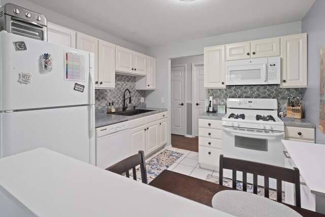 78 Holmes Way Unit W1, Schaumburg, IL 60193 - kitchen with white appliances, decorative backsplash, white cabinets, light tile patterned floors, and light countertops