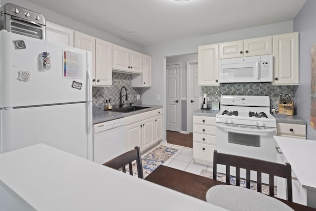 78 Holmes Way Unit W1, Schaumburg, IL 60193 - kitchen with white appliances, decorative backsplash, white cabinets, light tile patterned floors, and light countertops