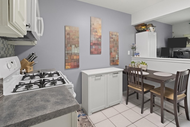 78 Holmes Way Unit W1, Schaumburg, IL 60193 - kitchen with white gas stove, white cabinets, and light tile patterned floors