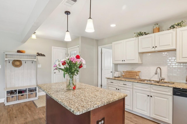 16301 Sherwood Dr, Orland Park, IL 60462 - kitchen featuring dishwasher, light stone countertops, tasteful backsplash, white cabinets, and light wood finished floors