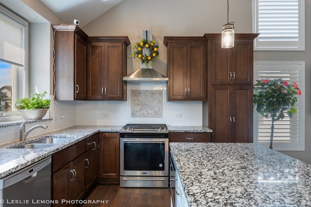 565 Sudbury Cir Unit 0, Oswego, IL 60543 - kitchen with appliances with stainless steel finishes, wall chimney exhaust hood, vaulted ceiling, tasteful backsplash, and light stone countertops