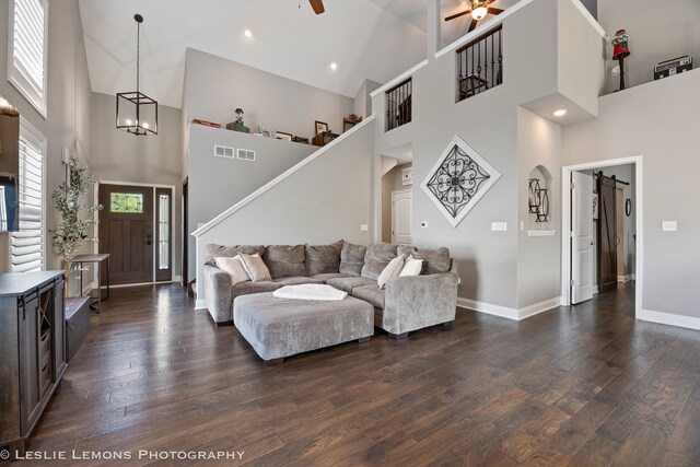 565 Sudbury Cir Unit 0, Oswego, IL 60543 - living area with a ceiling fan, a towering ceiling, dark wood-style floors, stairway, and a chandelier