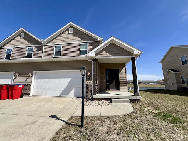 1320 Myrtle Beach Ave, Champaign, IL 61822 - view of front facade featuring driveway, an attached garage, and covered porch