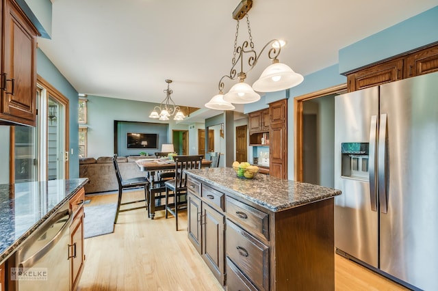 3624 Eliot Ln, Naperville, IL 60564 - kitchen featuring appliances with stainless steel finishes, a center island, a chandelier, and light wood finished floors