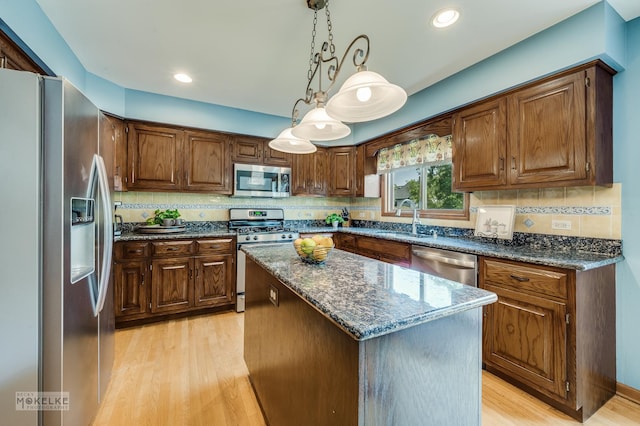 3624 Eliot Ln, Naperville, IL 60564 - kitchen with stainless steel appliances, light wood finished floors, a center island, dark stone countertops, and recessed lighting