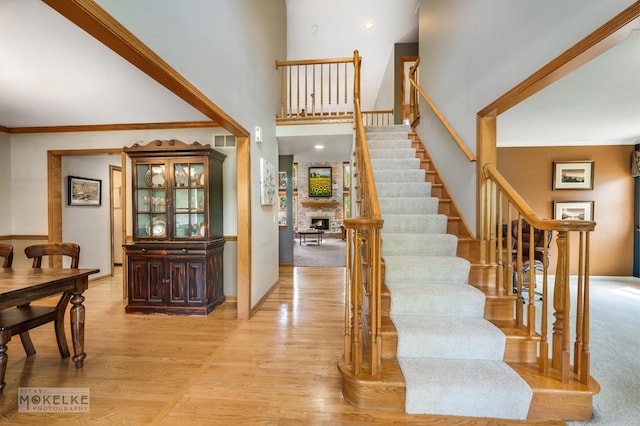 3624 Eliot Ln, Naperville, IL 60564 - stairs with a towering ceiling, wood finished floors, a large fireplace, and ornamental molding