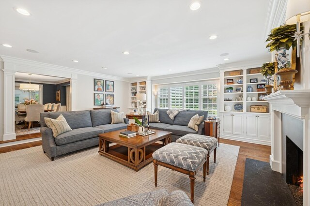 611 Oak Knoll Dr, Lake Forest, IL 60045 - living area featuring crown molding, wood finished floors, a fireplace with flush hearth, built in features, and recessed lighting