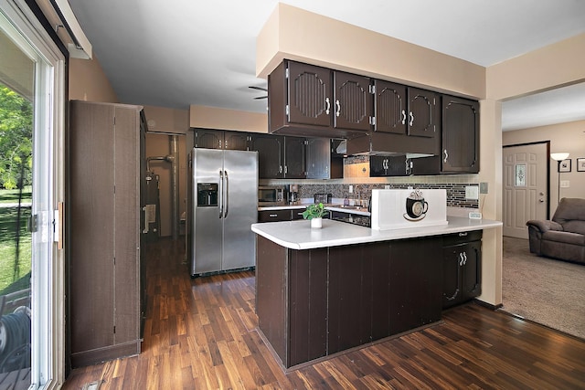 400 W Adams St, Danforth, IL 60930 - kitchen with stainless steel appliances, a peninsula, light countertops, decorative backsplash, and dark wood-type flooring