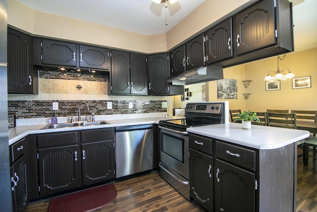 400 W Adams St, Danforth, IL 60930 - kitchen with appliances with stainless steel finishes, under cabinet range hood, a peninsula, and dark wood-style flooring