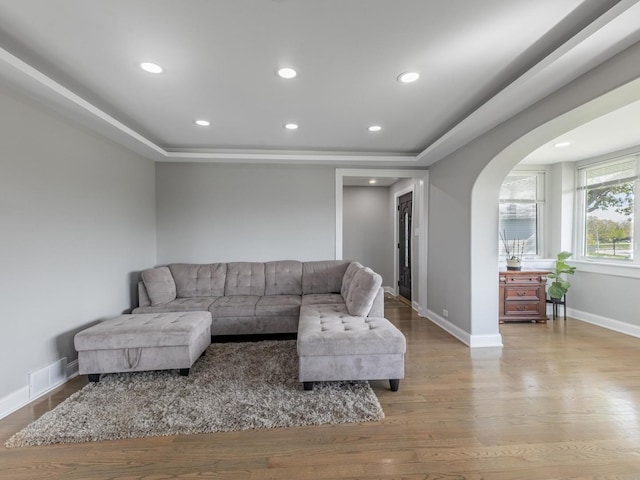 9712 W Shore Dr, Oak Lawn, IL 60453 - living room featuring arched walkways, wood finished floors, recessed lighting, and a tray ceiling