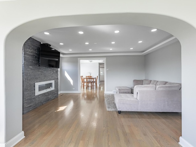 9712 W Shore Dr, Oak Lawn, IL 60453 - living room with a fireplace, wood finished floors, arched walkways, recessed lighting, and a tray ceiling