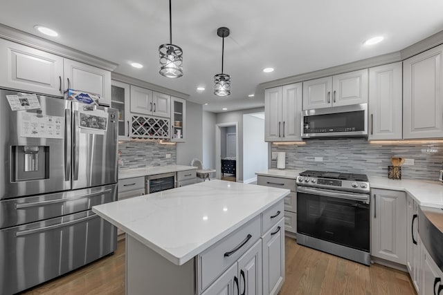 9712 W Shore Dr, Oak Lawn, IL 60453 - kitchen featuring appliances with stainless steel finishes, wine cooler, tasteful backsplash, recessed lighting, and a center island