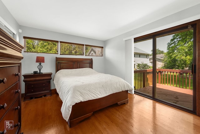 641 E Belmont Ave, Addison, IL 60101 - bedroom featuring multiple windows, access to exterior, and wood finished floors