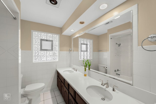 641 E Belmont Ave, Addison, IL 60101 - full bath featuring tile walls, tile patterned floors, double vanity, washtub / shower combination, and wainscoting