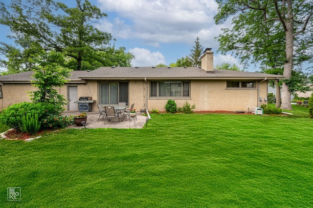 641 E Belmont Ave, Addison, IL 60101 - back of property featuring a chimney, a patio area, brick siding, and a lawn