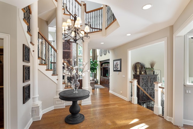 1091 Johnson Dr, Naperville, IL 60540 - foyer featuring wood finished floors, ornate columns, and recessed lighting