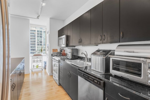 8 E Randolph St Unit 1401, Chicago, IL 60601 - kitchen with appliances with stainless steel finishes, light wood-type flooring, dark countertops, and rail lighting