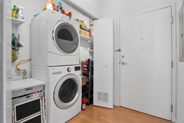8 E Randolph St Unit 1401, Chicago, IL 60601 - laundry area featuring stacked washer / drying machine and light wood-style flooring