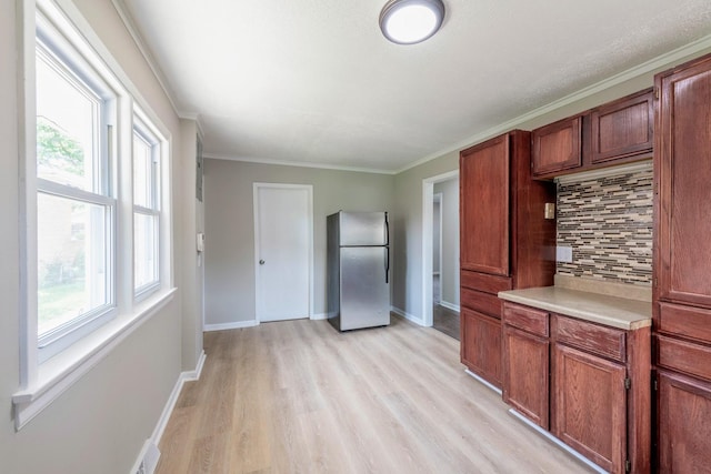 14415 Avalon Ave, Dolton, IL 60419 - kitchen with freestanding refrigerator, decorative backsplash, light wood-style floors, light countertops, and crown molding
