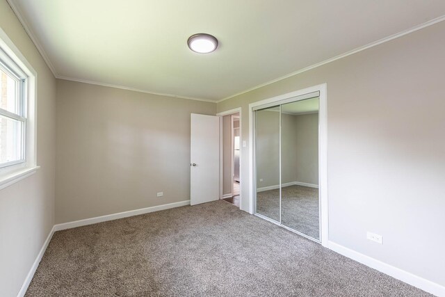 14415 Avalon Ave, Dolton, IL 60419 - unfurnished bedroom with carpet floors, crown molding, and a closet