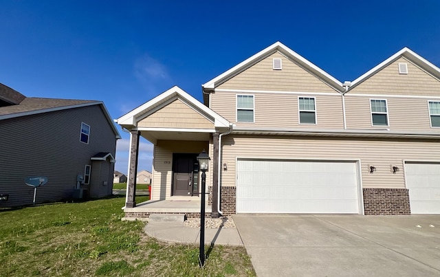1318 Myrtle Beach Ave, Champaign, IL 61822 - view of front of house featuring brick siding, an attached garage, driveway, and a front lawn