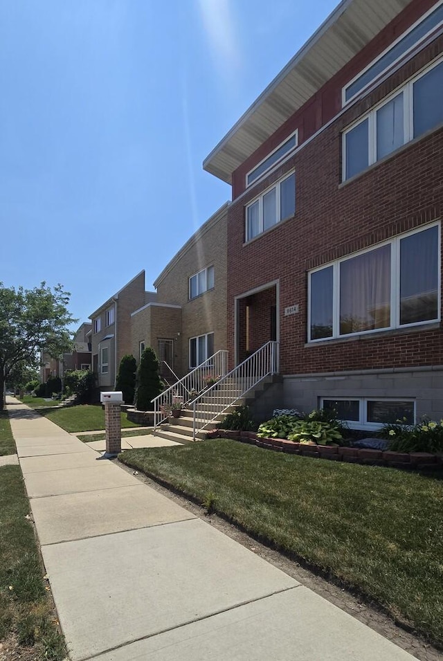 8620 S Normal Ave, Chicago, IL 60620 - view of front of house with brick siding, a front lawn, and a residential view