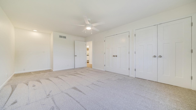 1320 Lake Summerset Rd, Davis, IL 61019 - unfurnished bedroom with light carpet, two closets, and ceiling fan