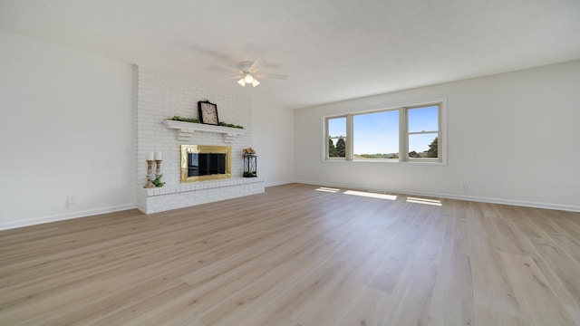 1320 Lake Summerset Rd, Davis, IL 61019 - unfurnished living room featuring ceiling fan, light wood-type flooring, and a fireplace