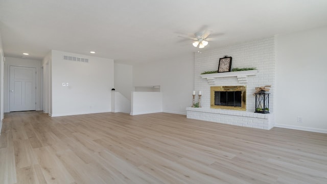 1320 Lake Summerset Rd, Davis, IL 61019 - unfurnished living room with a ceiling fan, light wood-style flooring, recessed lighting, and a brick fireplace