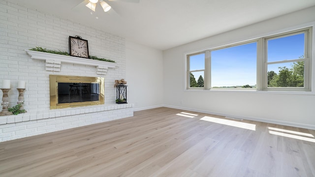 1320 Lake Summerset Rd, Davis, IL 61019 - unfurnished living room featuring a fireplace, a ceiling fan, and wood finished floors