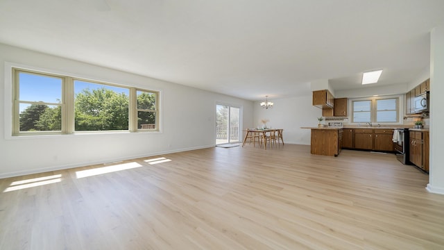 1320 Lake Summerset Rd, Davis, IL 61019 - unfurnished living room with light wood finished floors and a chandelier