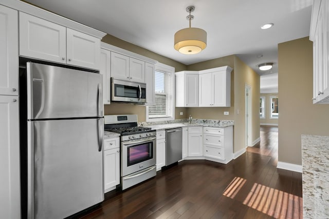 2732 W Belmont Ave, Chicago, IL 60618 - kitchen with appliances with stainless steel finishes, dark wood-type flooring, white cabinetry, light stone counters, and recessed lighting