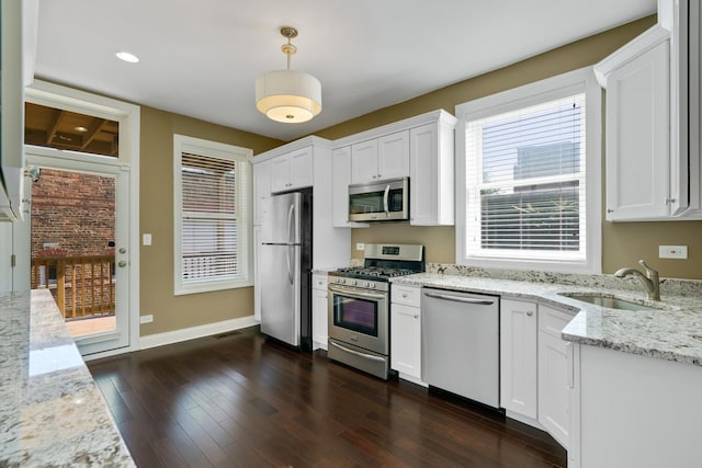 2732 W Belmont Ave, Chicago, IL 60618 - kitchen featuring stainless steel appliances, white cabinets, dark wood-style floors, pendant lighting, and recessed lighting