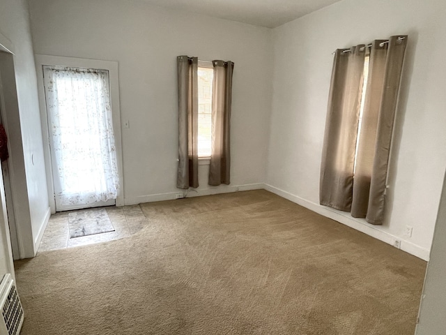 42 2nd St, Lasalle, IL 61301 - empty room with plenty of natural light and carpet flooring