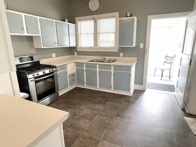 42 2nd St, Lasalle, IL 61301 - kitchen with stainless steel gas range, light countertops, and dark tile patterned flooring