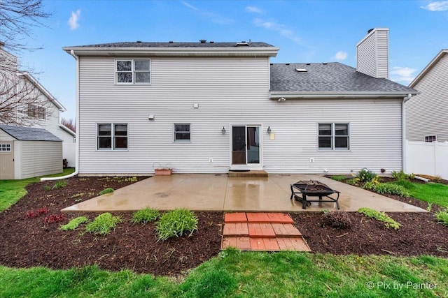 514 Doral Ln, North Aurora, IL 60542 - rear view of property with a patio, an outdoor fire pit, a storage shed, a chimney, and a shingled roof