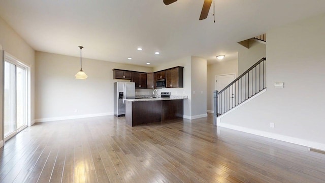 1516 Stonebluff Ct, Champaign, IL 61822 - kitchen featuring stainless steel appliances, open floor plan, dark brown cabinets, ceiling fan, and light wood-type flooring