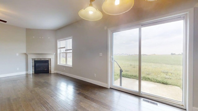 1516 Stonebluff Ct, Champaign, IL 61822 - unfurnished living room with wood-type flooring, a tiled fireplace, and ceiling fan